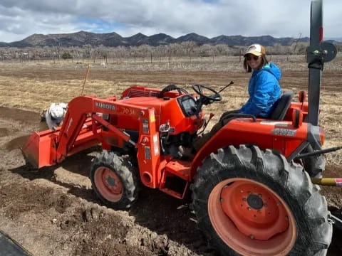 a person driving a tractor