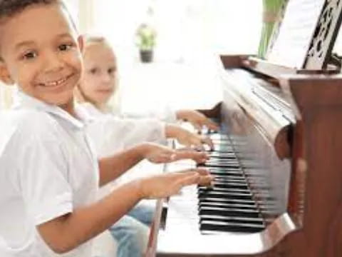 a young boy playing a piano