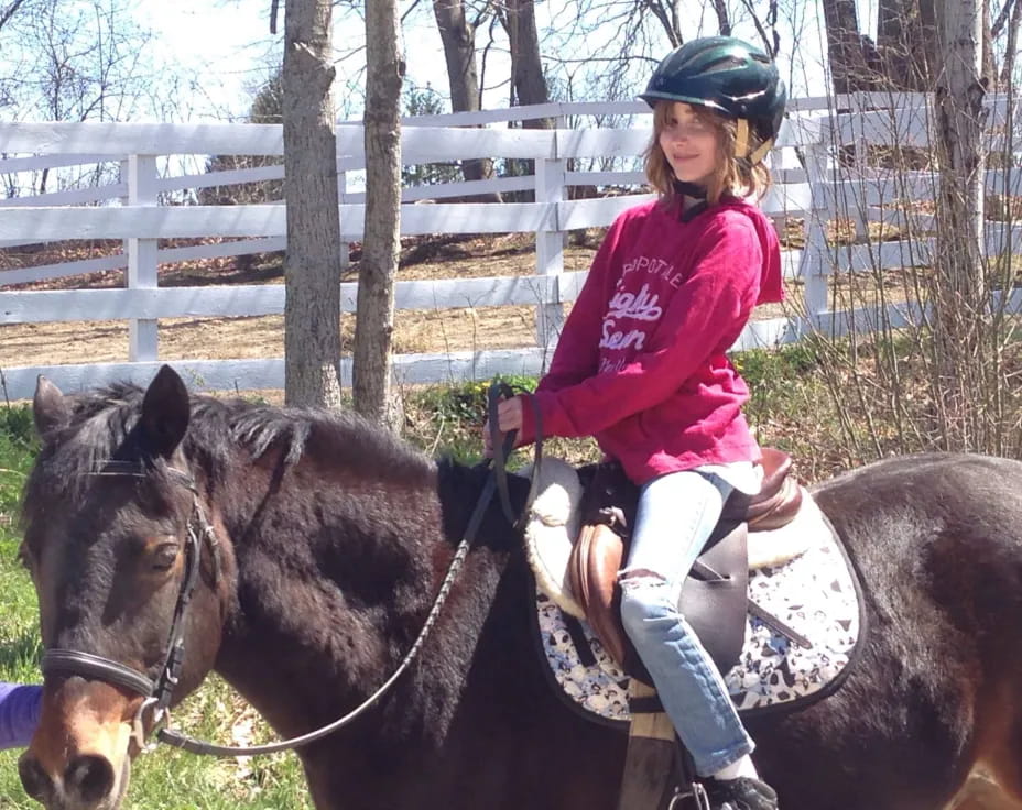 a girl riding a horse