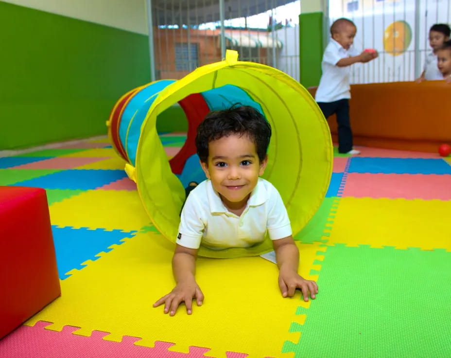 a child sitting on a colorful mat