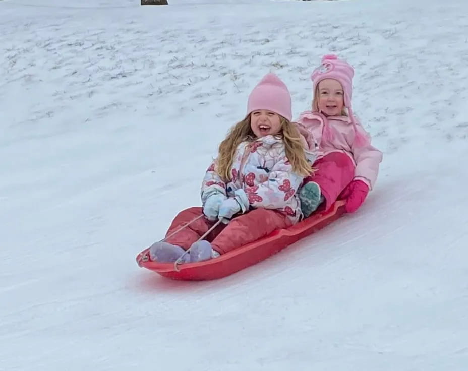 two girls in a sled in the snow