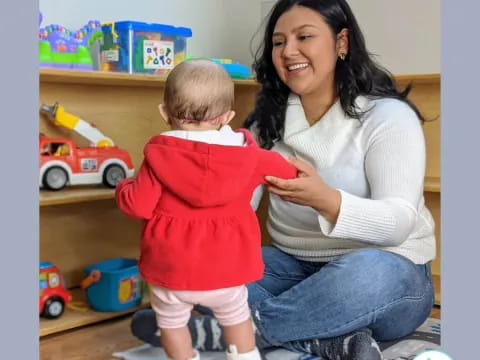 a woman holding a baby