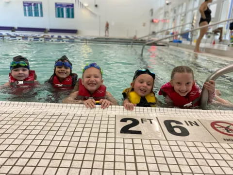 a group of kids in a pool
