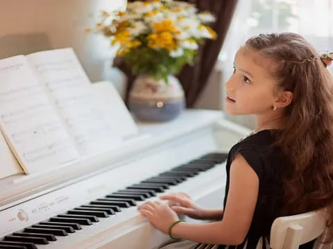 a woman playing a piano