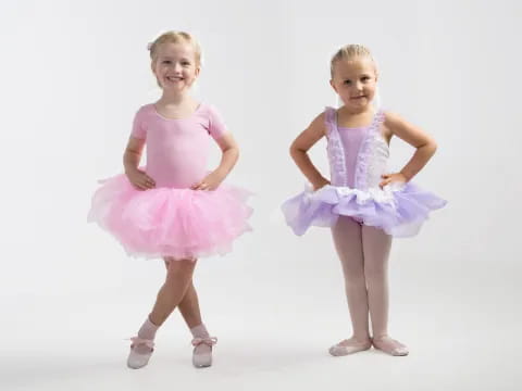 a couple of girls wearing dresses