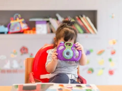 a girl holding a toy