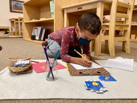 a young boy painting on a table