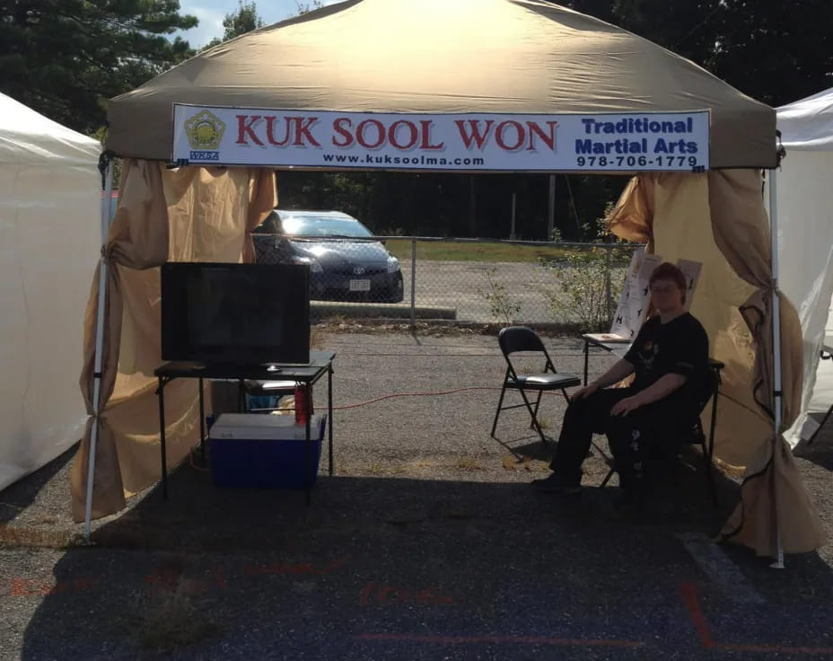 a person sitting under a tent
