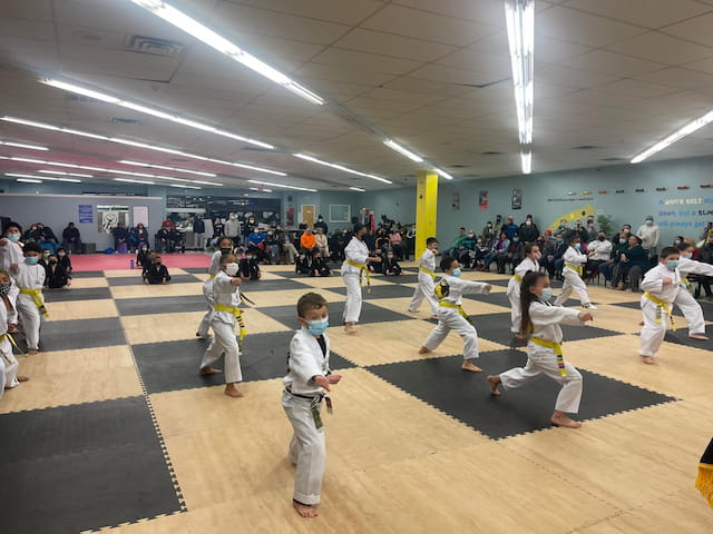 a group of people in karate uniforms