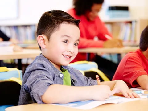 a boy sitting at a desk