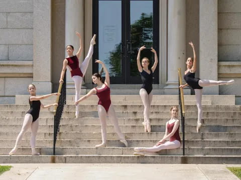 a group of women posing on stairs