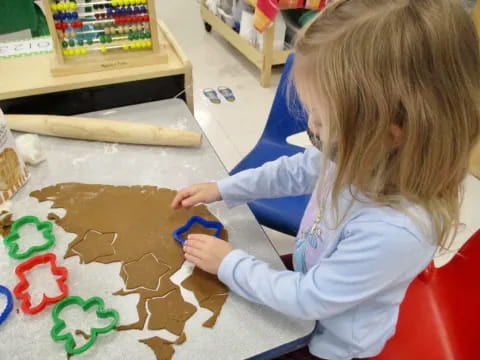 a young girl painting on a table