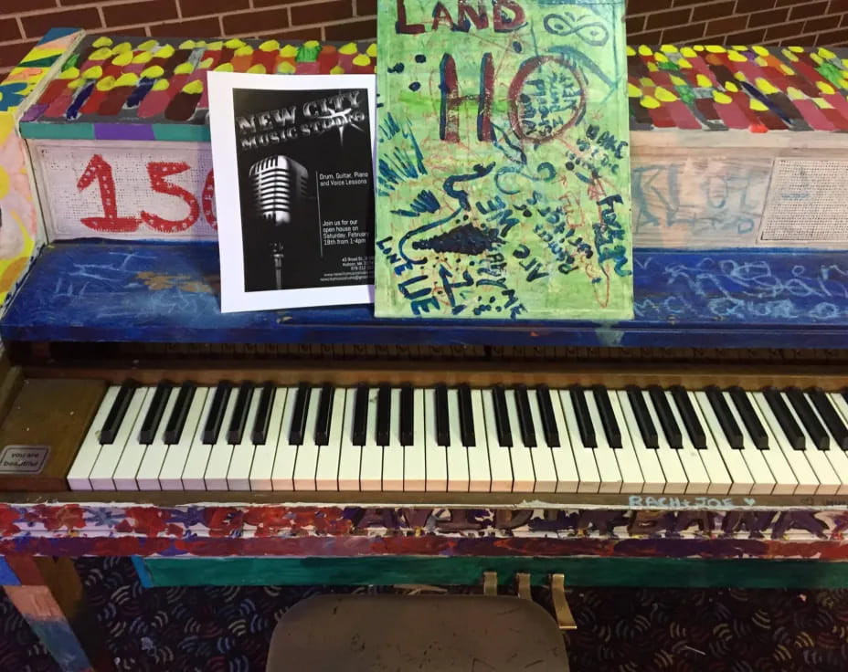 a piano with a sign on it