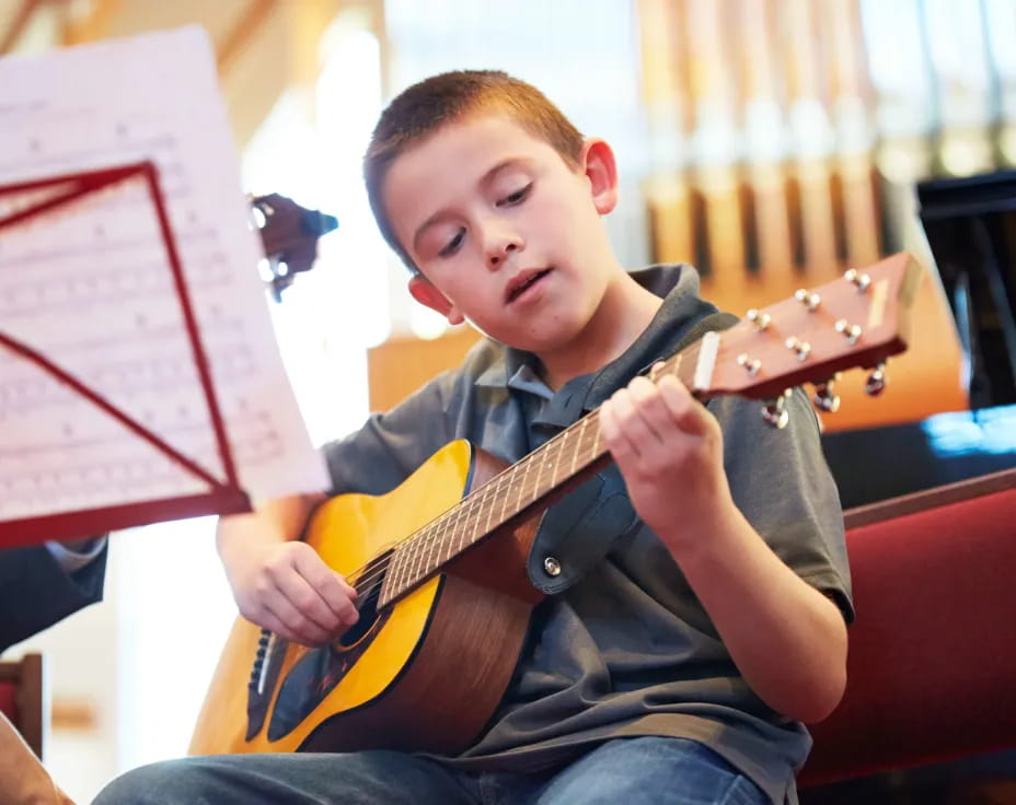 a boy playing a guitar