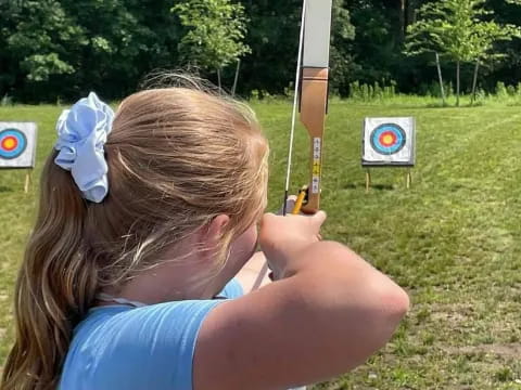 a woman holding a bow and arrow