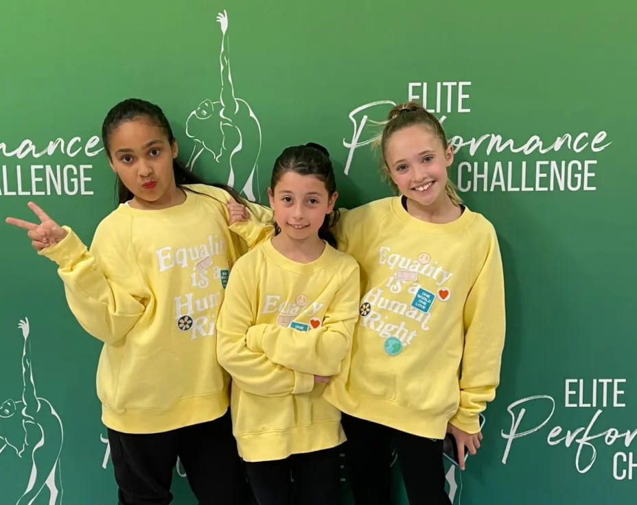 a group of girls in yellow shirts