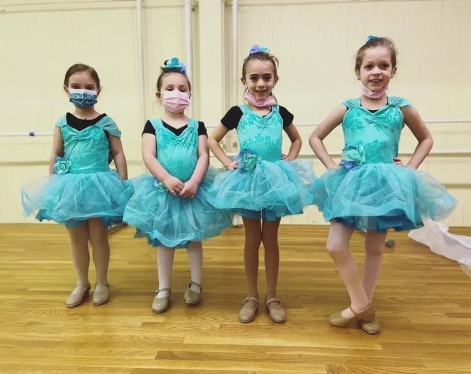 a group of girls in blue dresses