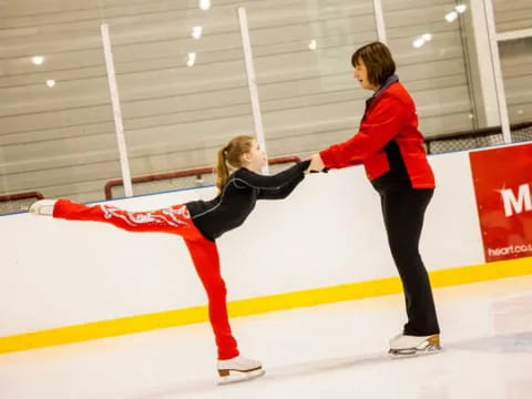 a couple of women ice skating
