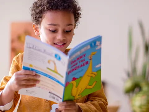 a young girl reading a book