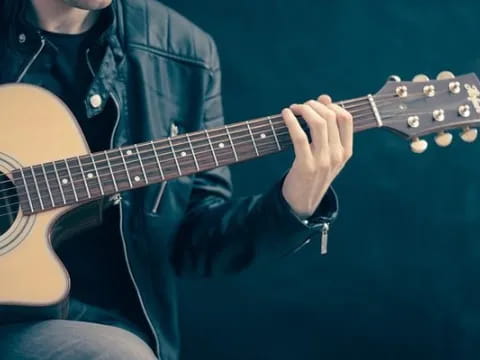 a person playing a guitar
