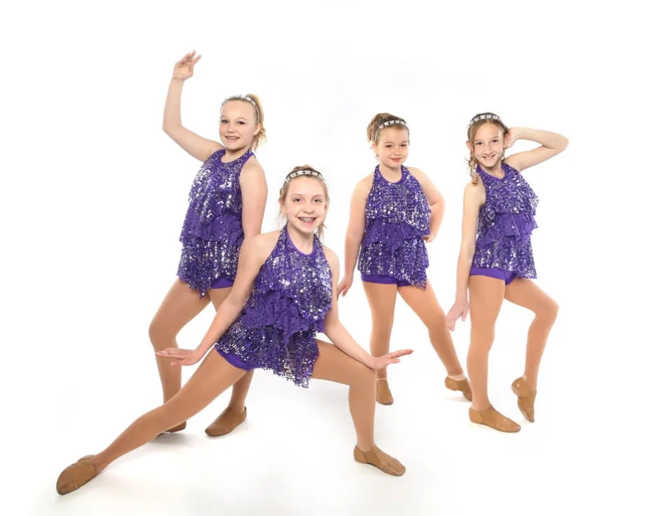a group of girls in dresses