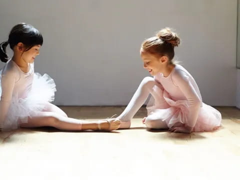 two girls sitting on the floor