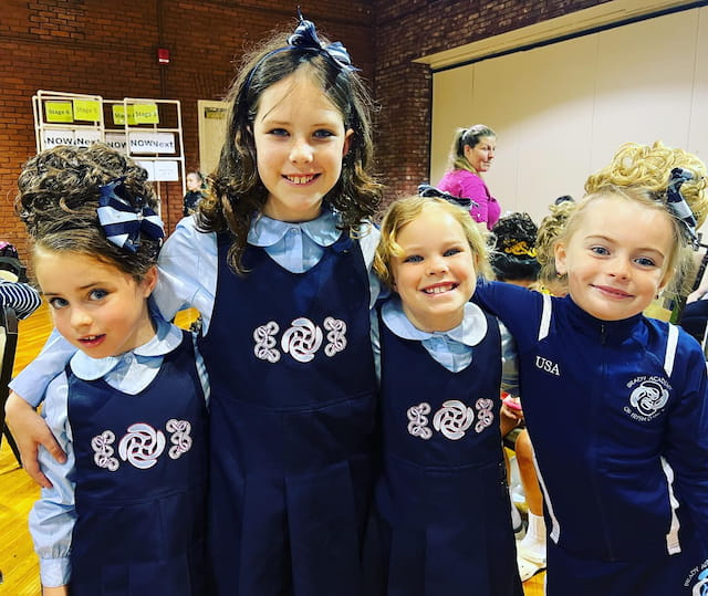 a group of girls in blue and black uniforms