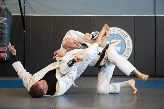 a person kicking another man in the face