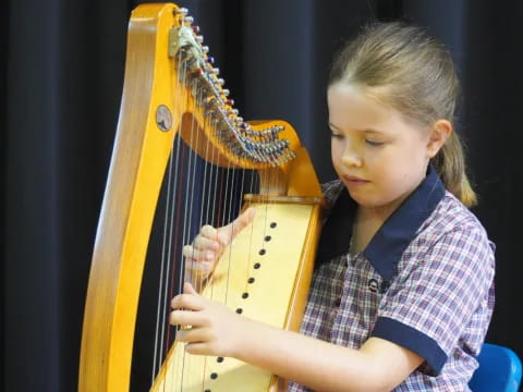 a young girl playing a cello