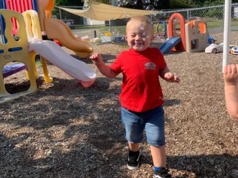 a boy standing in a playground
