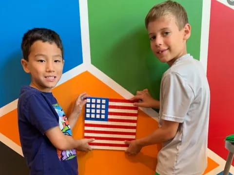 a couple of boys holding a flag