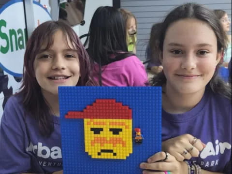 a group of girls holding a puzzle