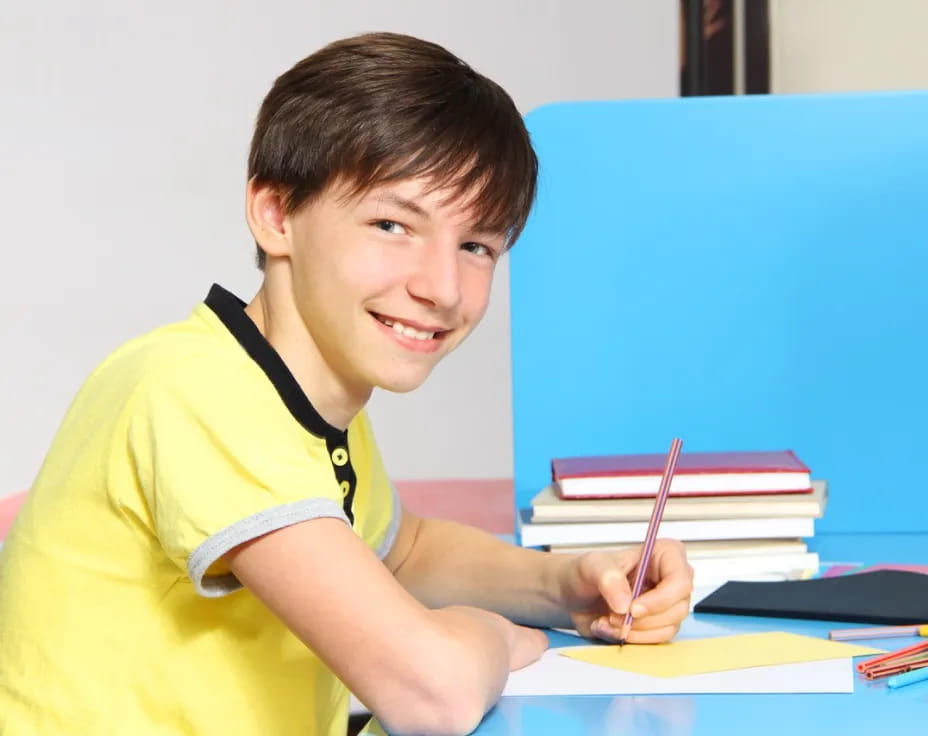 a boy sitting at a desk