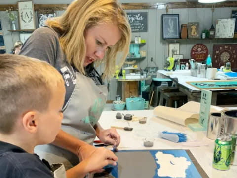 a person and a boy painting