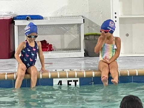 a couple of kids in a pool
