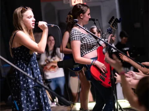 a man and woman singing on stage