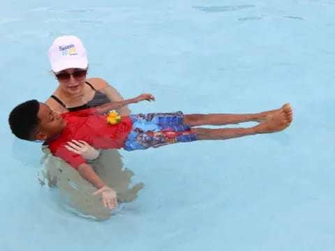 a person and a boy in the water