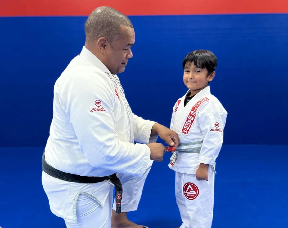 a man and a boy in karate uniforms