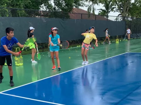 a group of people playing tennis