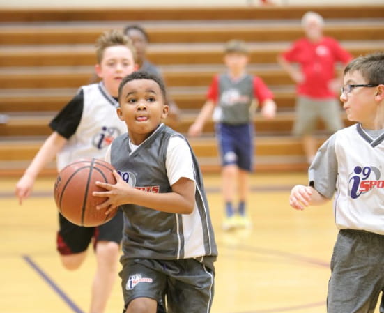 a group of kids playing basketball