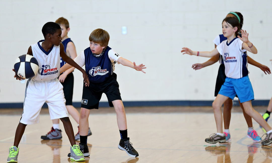 a group of kids playing basketball