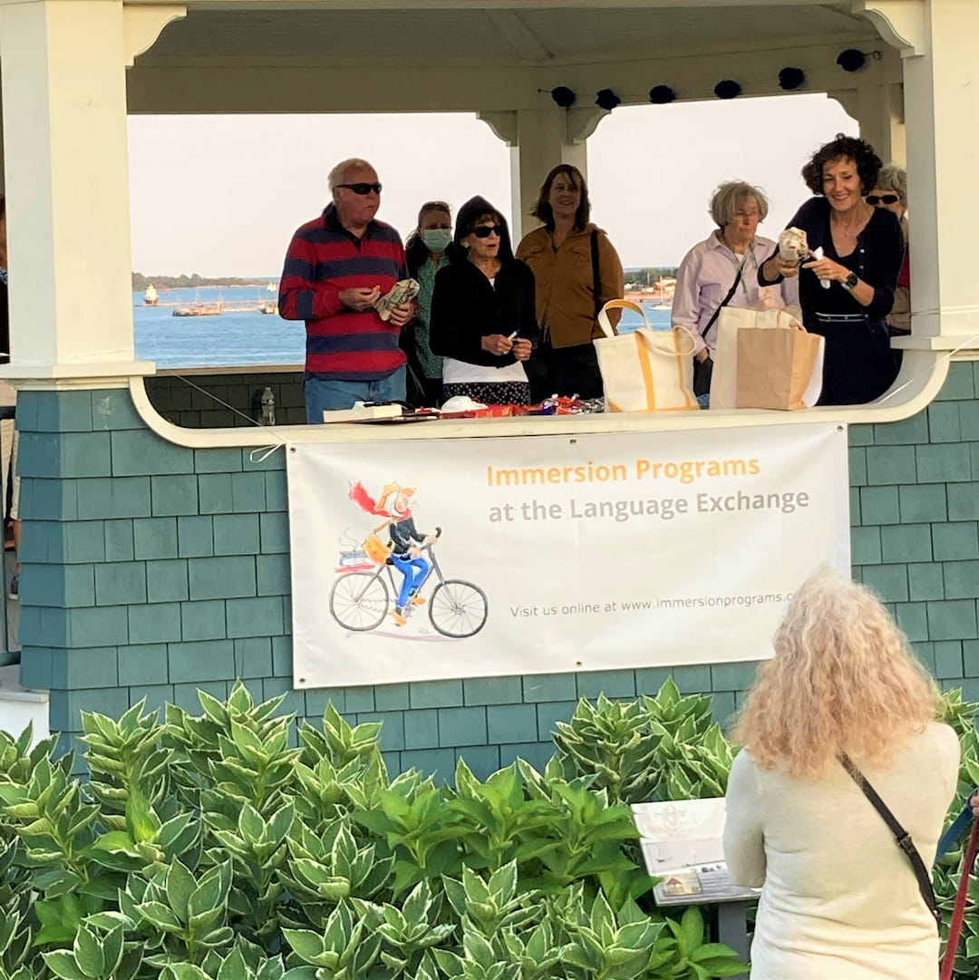 a group of people standing around a sign