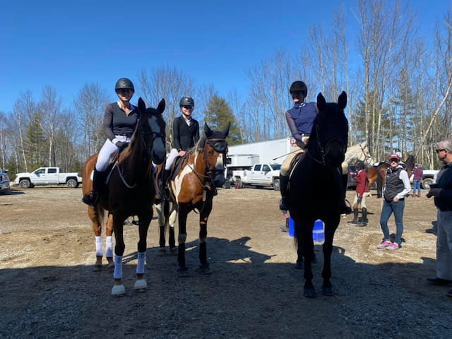 a group of people riding horses