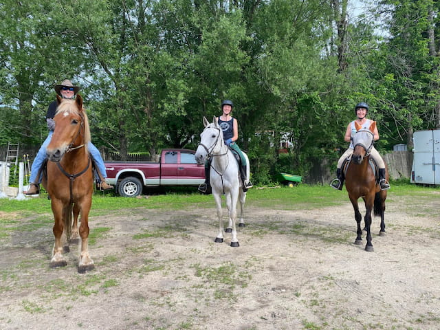 a group of people riding horses