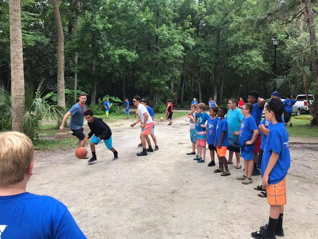 a group of people playing basketball