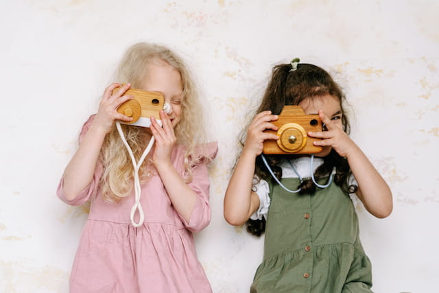 a couple of girls holding cameras