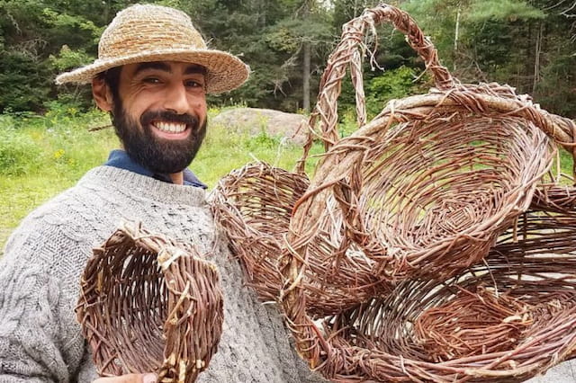 a man holding a bundle of straw