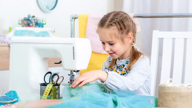 a little girl using a computer