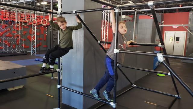 a couple of boys working out in a gym