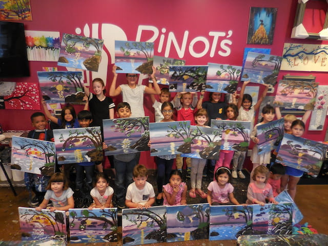 a group of children holding books